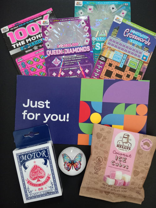 Just for You gift bundle showing scratch tickets, Motor Brand playing cards, Kellys Coconut Ice Cubes and butterfly glass magnet